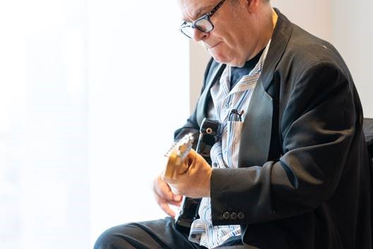 George B Wall playing the guitar